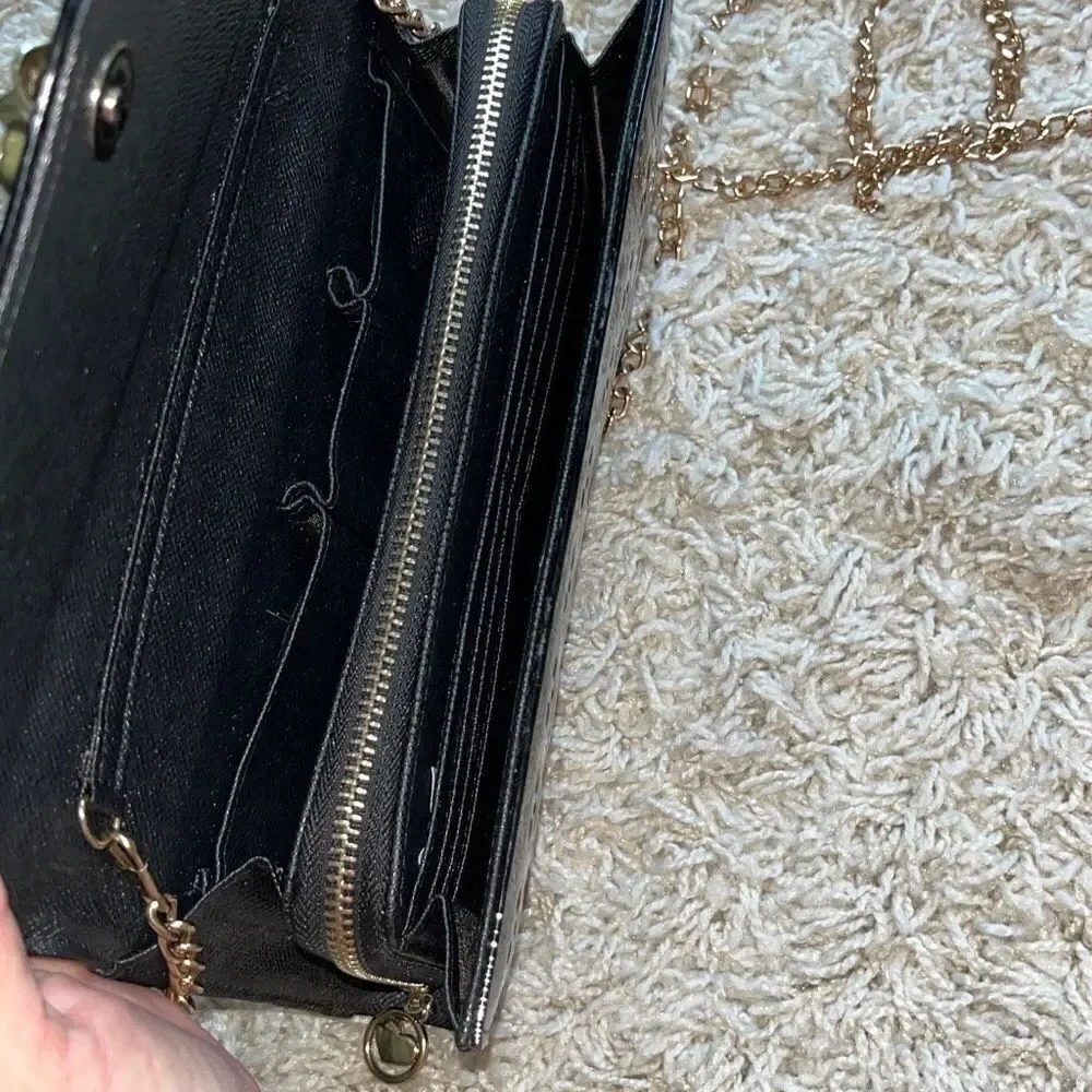 Awesome patent leather skull embossed clutch bag with gold chain shoulder strap.